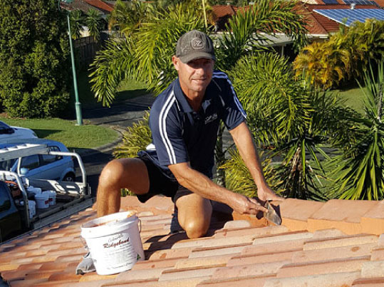 Rob on the roof preparing for painting